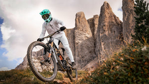 Mountain biker wearing Limar deep mint full face Livigno bike helmet