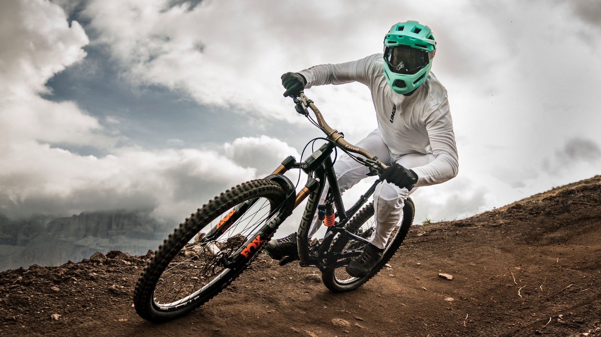 Mountain biker wearing Limar Livigno full face helmet while riding berm 